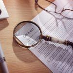 Magnifying glass on a legal contract