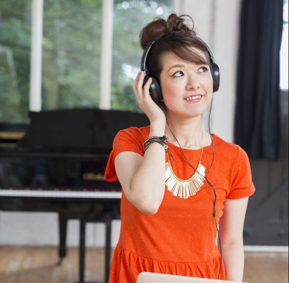 Young woman wearing headphones with a laptop